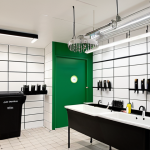 **

Prompt:  A bright, modern hair salon in the Netherlands. Focus on sustainability, showcasing water-saving showerheads, LED lighting, and clearly labeled recycling bins.  Stylists are efficiently using products with measuring tools.  Overall feeling of eco-consciousness and smart business. Interior design emphasizing Dutch minimalism.

**